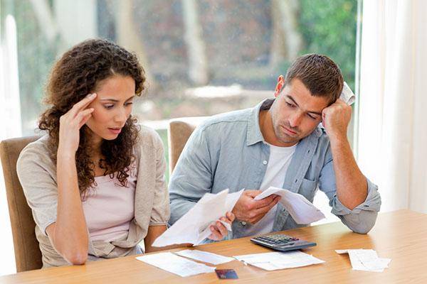 Couple calculating their costs looking shocked
