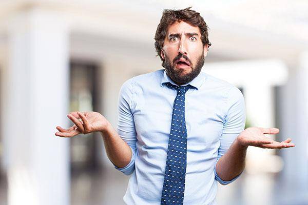 A man shrugging looking confused