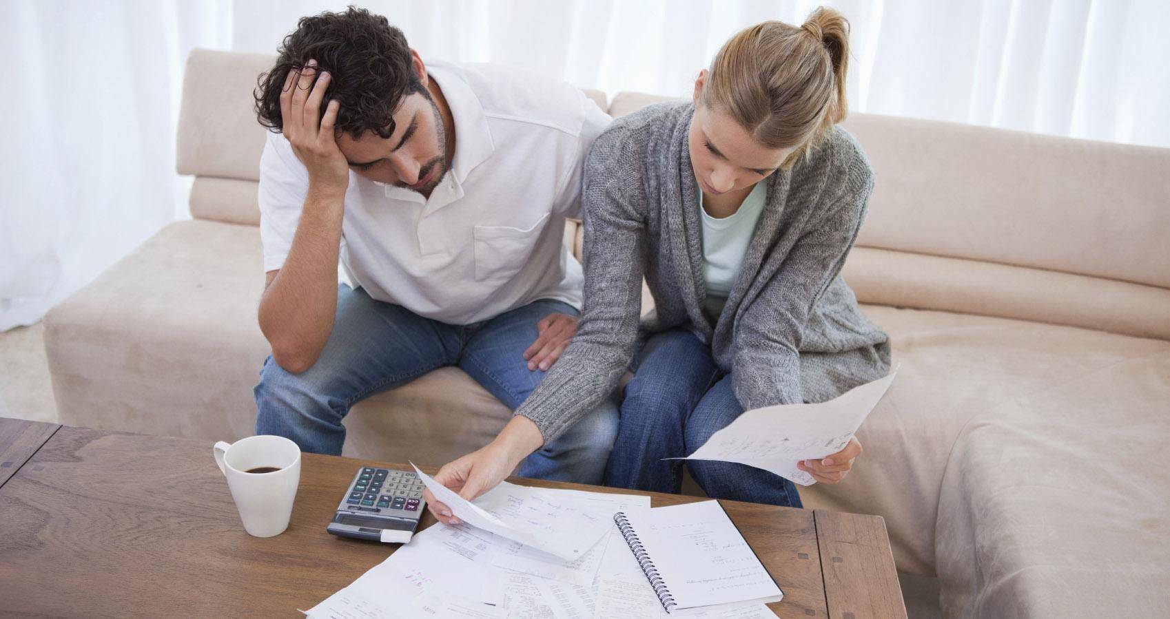 Couple looking stressed going through bills